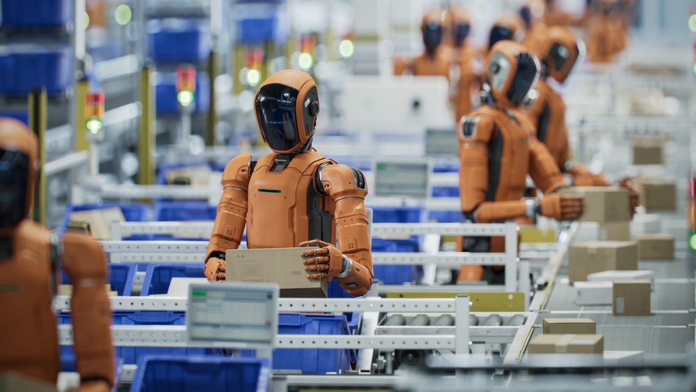 Orange humanoid robots sorting parcels along a warehouse conveyor line